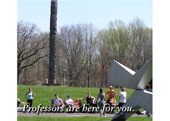 students lounging on grass with 'professors are here for you.'