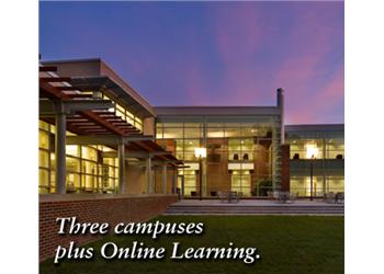 evening view of modern campus building with 'three campuses plus online learning.'