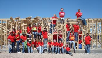 group of volunteers posing on construction site