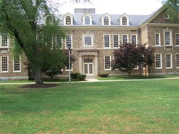 historic brick building with green lawn