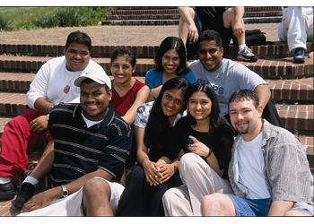 group of students sitting on steps outdoors