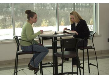 two students studying at a table indoors