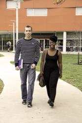 two students walking outside a campus building