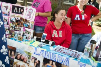 students at club fair with promotional items