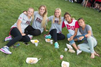 students seated on grass wearing 'esu' shirts at picnic