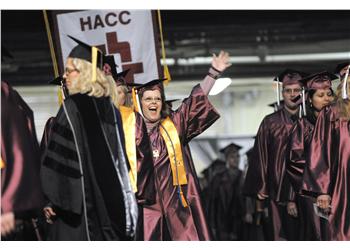 graduates in maroon gowns at commencement