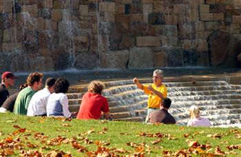 group sitting outdoors near a water cascade