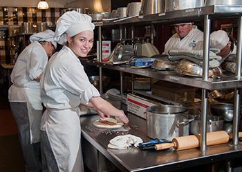 culinary student preparing food in kitchen