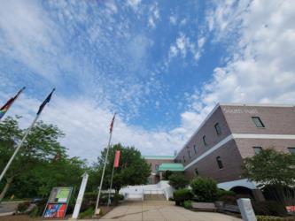 cloudy sky above campus architecture