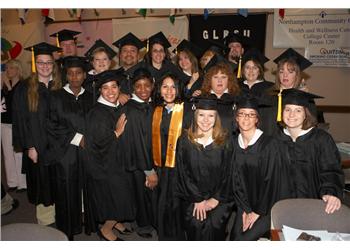 graduates smiling in caps and gowns