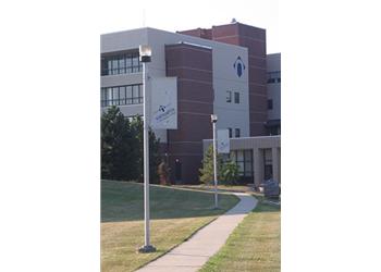 campus building with logo and flags