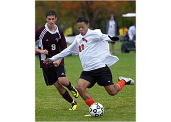 soccer player dribbling on field