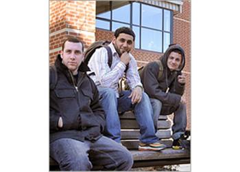 students sitting on steps outside a building