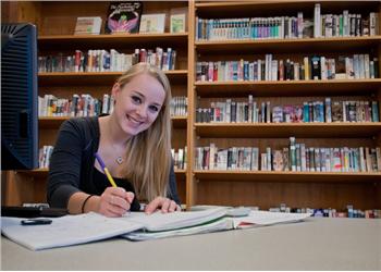 student studying in library