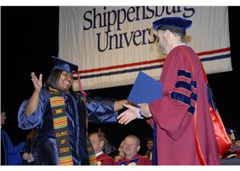 graduation ceremony with 'Shippensburg University' banner