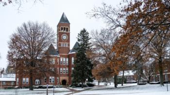 campus building with clock tower in snow