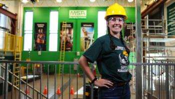 student in hard hat by 'msa safety' sign