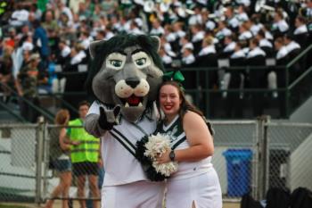 mascot with cheerleader on football field