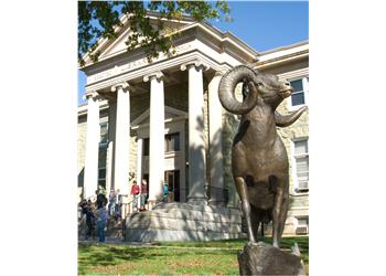 building entrance with a statue of a ram