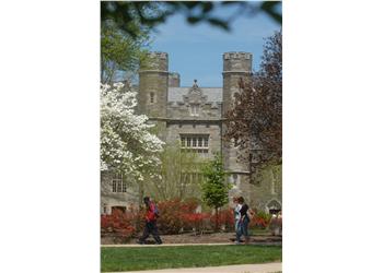 students walking by a castle-like building