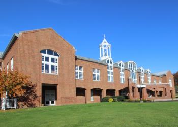 brick building with white accents under blue sky