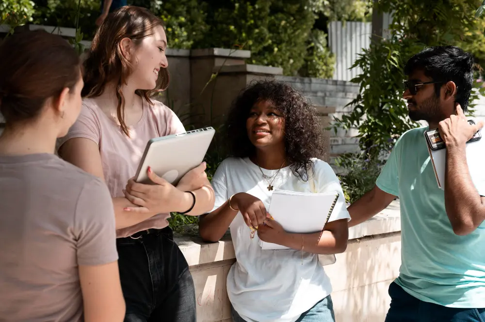 four students talking on college campus