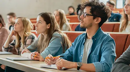 students in classroom listening to teacher